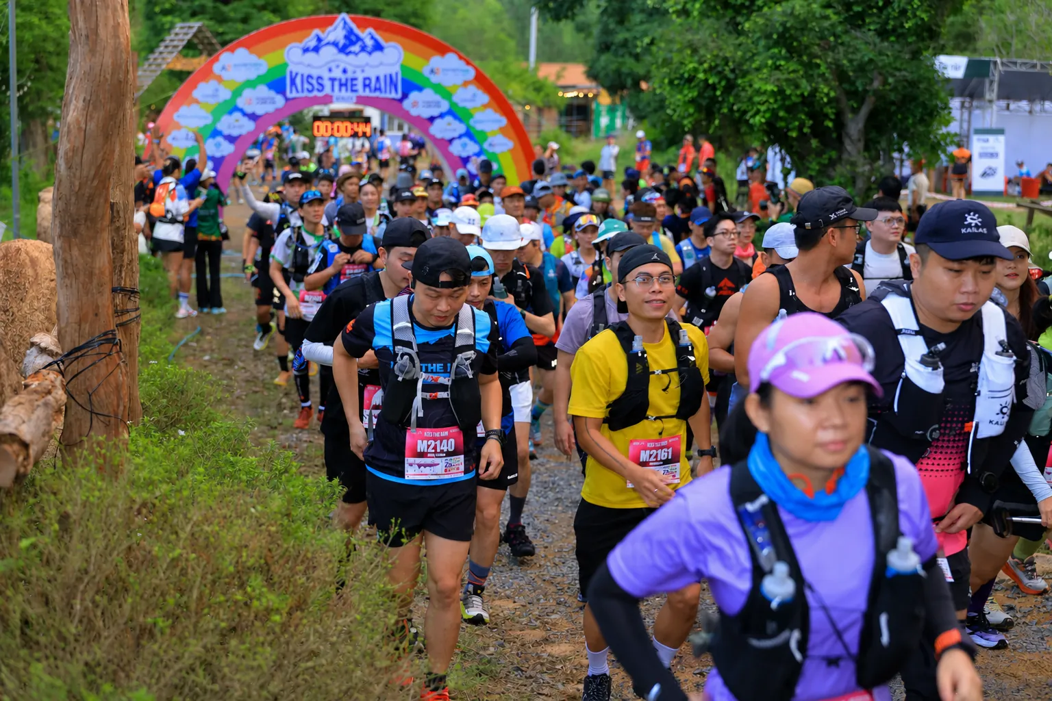 Runner holding Highbrid Club flag at The Explorer Trail finish
