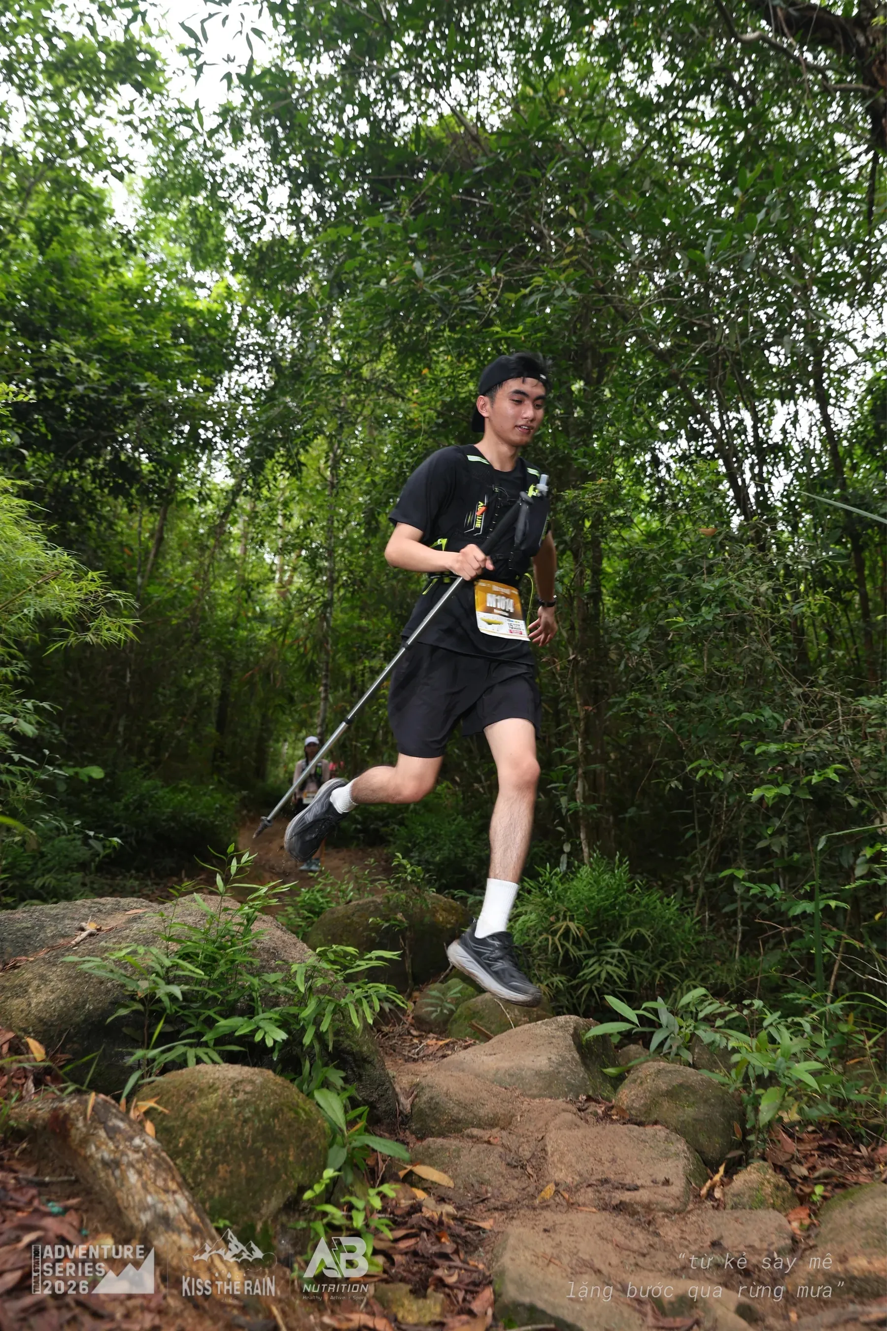 Runner celebrating with hands up on the trail